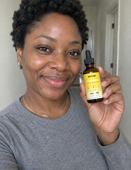Customer in a gray top holding a VitalDrops bottle