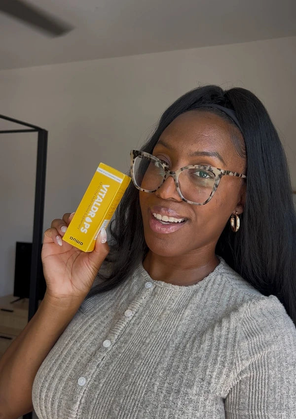 Customer with glasses holding a VitalDrops box