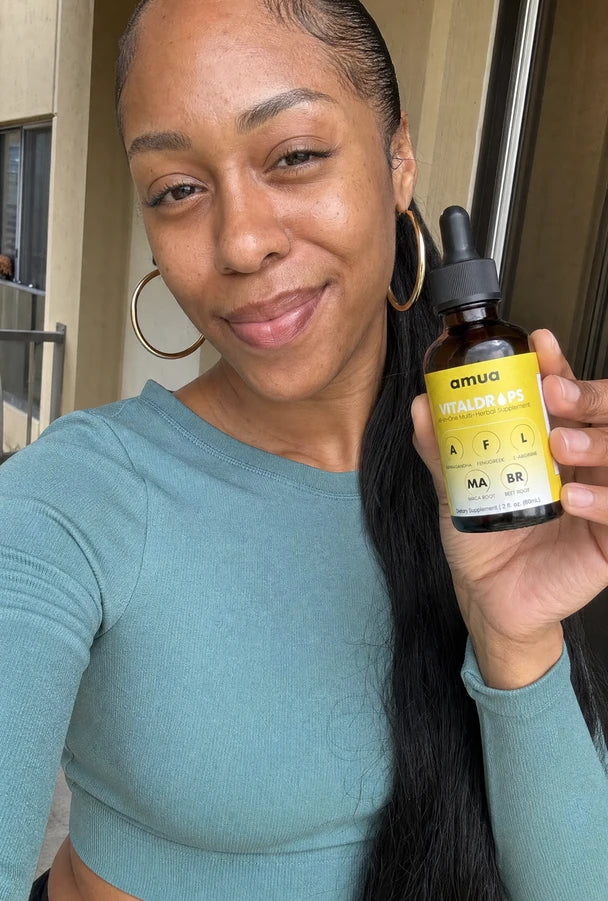 Customer in a teal top holding a VitalDrops bottle