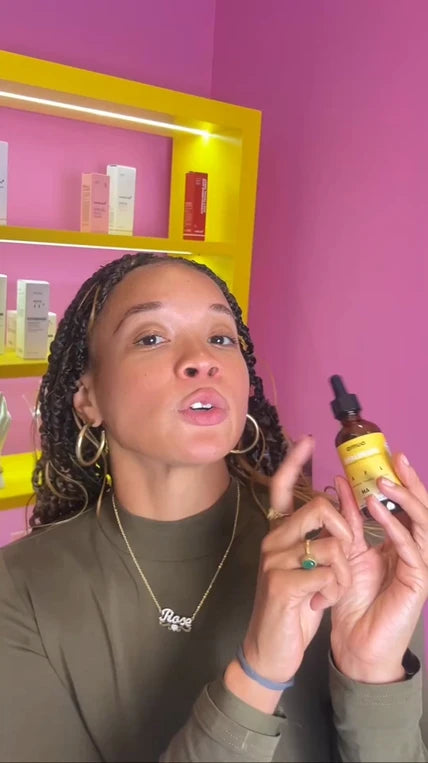 Customer in a pink room showing a VitalDrops bottle